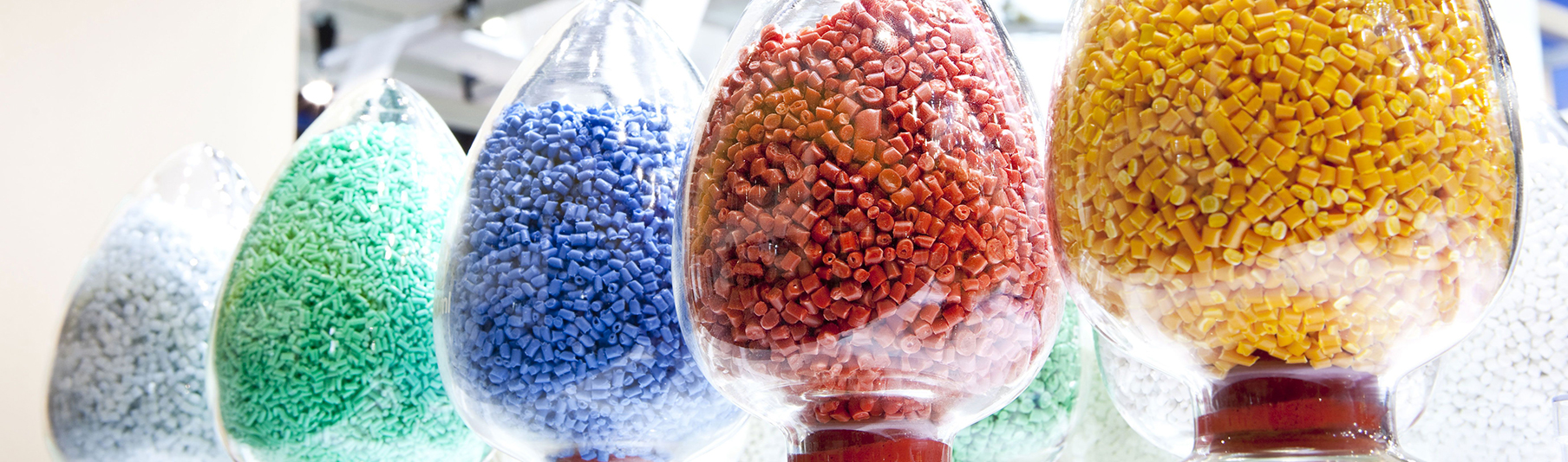 Manufacturing Insurance: A row of colourful manufactured pieces sitting in glass containers